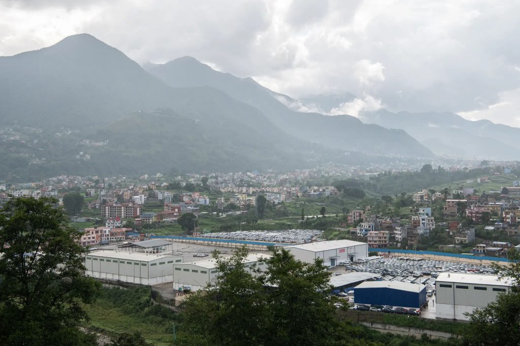 Newly imported electric vehicles parked at Chobhar dry port, not far from the capital of Nepal, Kathmandu.Credit...Rebecca Conway for The New York Times